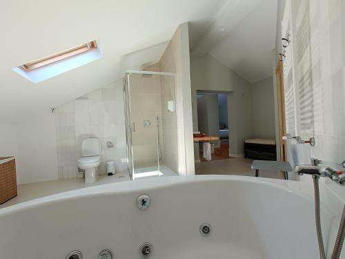 a large white bath tub in a bathroom at Quinta de Marzovelos in Viseu