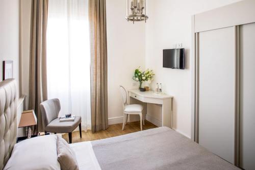 a hotel room with a bed and a desk at Hotel Lido in Alassio