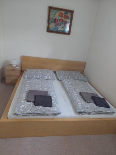 a bed with two pillows on top of it at Ubytování na Lipně in Černá v Pošumaví