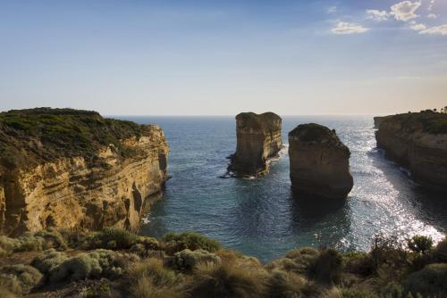 two large rocks in the water near the ocean at Port Campbell Parkview Motel & Apartments in Port Campbell