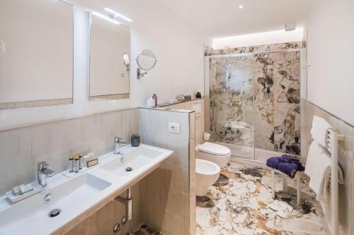 a bathroom with a sink and a toilet at Hotel Lido in Alassio