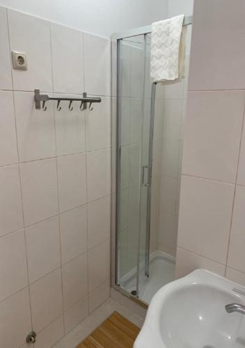 a bathroom with a shower and a sink at GuimaraesLiving - Hostel & Adventure in Guimarães