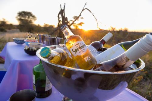 a bucket filled with bottles of beer on a table at Lindiwe Safari Lodge in Hoedspruit