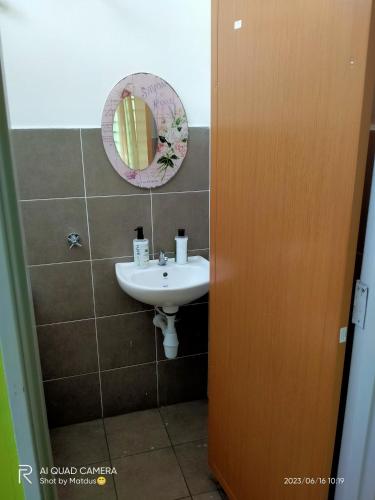 a bathroom with a sink and a mirror at NF Residents 2 in Alor Setar