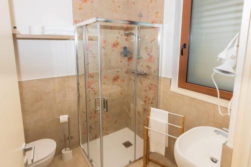 a bathroom with a shower with a toilet and a sink at Casale Ferrantino in Giulianova