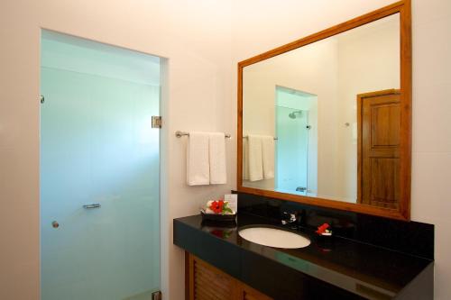 a bathroom with a sink and a mirror at Les Villas D'or in Baie Sainte Anne