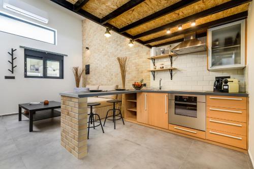 a kitchen with a counter and a table in it at Loft 2 in Kos