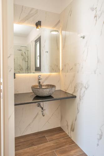 a bathroom with a sink and a mirror at Villa Fortuna in Agia Effimia