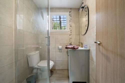 a bathroom with a toilet and a glass shower at Mas Guineu in Reus