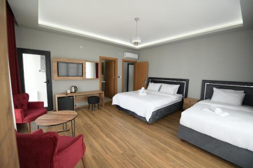 a hotel room with two beds and a desk at POAL GROUP HOTELS in Bostancı