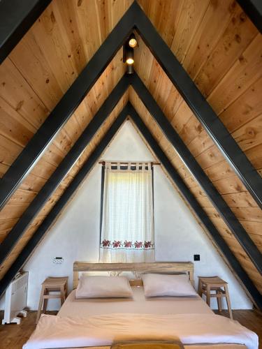 a bedroom with a bed in a attic at Tlos Nature Houses in Yaka