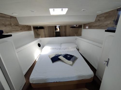 a small bed in the back of a boat at BED&BOAT II boatandholiday com in Fano
