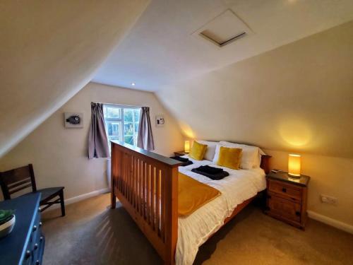 a bedroom with a large bed and a window at Court Cottage, 2 bed period house in Sarre