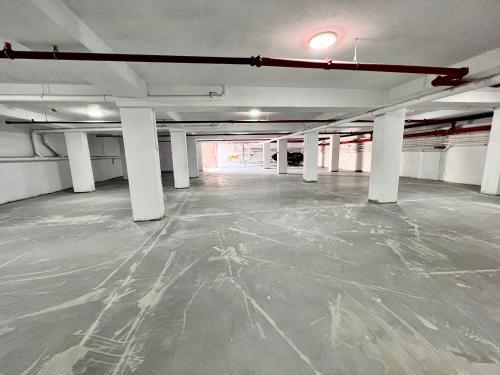 an empty parking garage with white columns and a ceiling at Atmosphere by the Sea in Eforie Nord