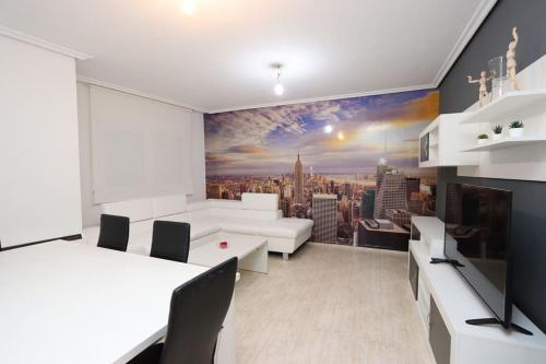 a living room with a large mural of a city at Apartamento DUQUES DE BÉJAR in Béjar