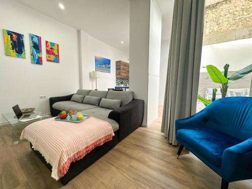 a living room with a couch and a blue chair at Capitan Rueda Apartments Alicante - Parking 10 euros per day in Alicante