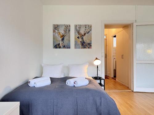 a bedroom with a bed with two paintings on the wall at Studio Apartment In Herlev, Herlevgrdsvej 4, 3 in Herlev