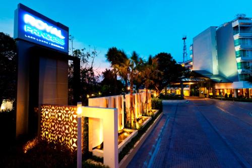 a sign on the side of a street at night at Royal Princess Larn Luang - SHA Extra Plus in Bangkok