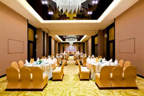 a banquet hall with tables and chairs and a chandelier at Royal Princess Larn Luang - SHA Extra Plus in Bangkok