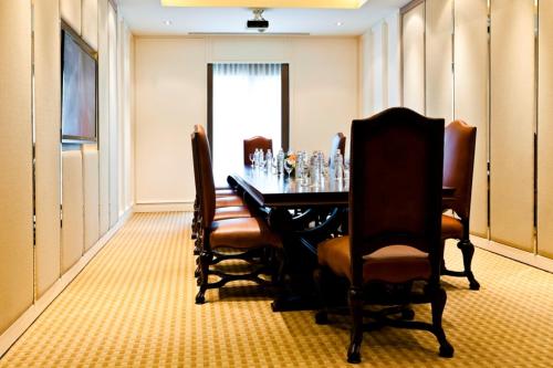 a dining room with a table and chairs at Royal Princess Larn Luang - SHA Extra Plus in Bangkok