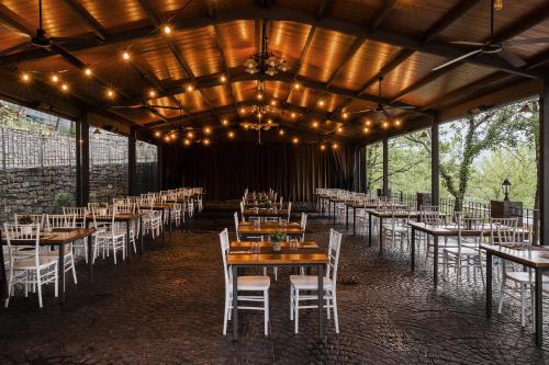 a dining room with tables and chairs and lights at wecamp Pirineos in Boltaña