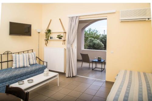 a hotel room with a bed and a window at Diamond Palace in Gythio