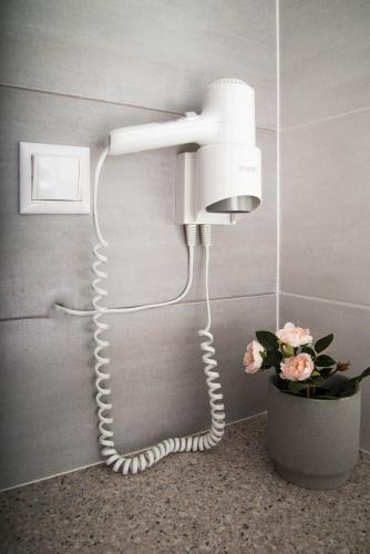 a white phone is attached to a wall at Diamond Palace in Gythio