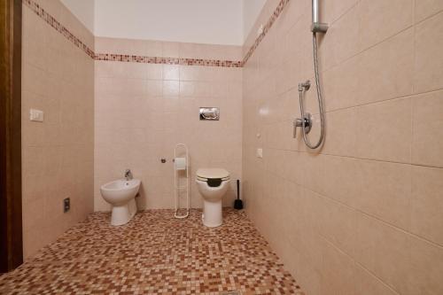 a bathroom with a toilet and a sink and a shower at Antichi Palmenti - Corbezzolo in San Vincenzo