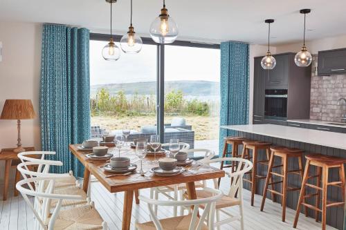 a kitchen and dining room with a table and chairs at Beach House in Pennygown