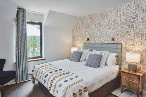 a bedroom with a large bed and a window at Beach House in Pennygown