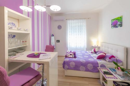 a small bedroom with a bed and a desk at Apartments Trend in Rijeka
