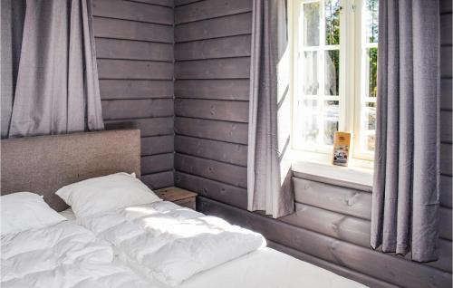 a bedroom with a bed and a window at 3 Bedroom Lake Front Home In Sperrebotn in Sperrebotn
