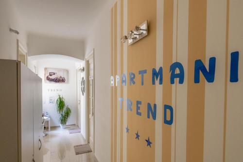 a hallway with a striped wall with the words antenna rental at Apartments Trend in Rijeka