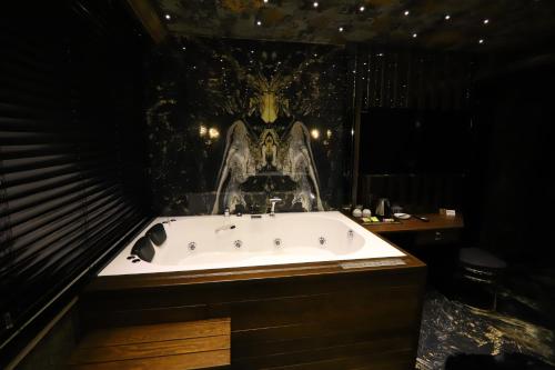 a bathroom with a bath tub with a skull on the wall at Bayrak Grand Hotel in Trabzon