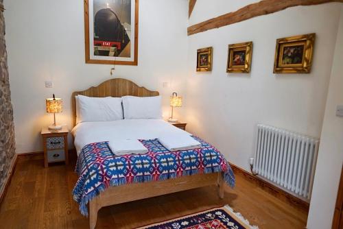 a bedroom with a bed with two lamps and a rug at Nest Holiday Hideaway Dove Barn Amazing location! in Church Stretton