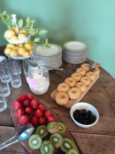 a wooden table topped with lots of different types of fruit at Valle di Mare Country Resort in Fontane Bianche