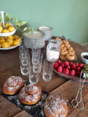 a table topped with donuts and glasses of water at Valle di Mare Country Resort in Fontane Bianche