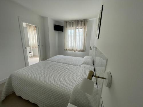 Ένα ή περισσότερα κρεβάτια σε δωμάτιο στο Hostal Montevideo beachfront