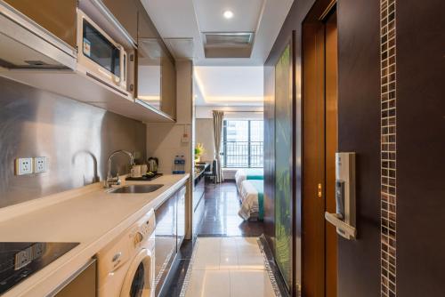 a kitchen with a sink and a dishwasher at Livetour Hotel Kehui Golden Valley Guanzhou in Guangzhou