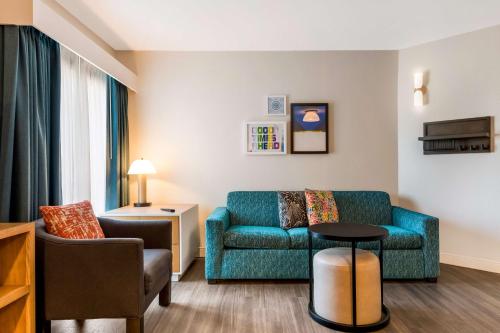 a living room with a couch and a table at Sonesta ES Suites Orlando International Drive in Orlando