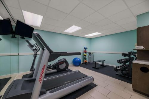 a gym with a treadmill and weights in a room at Sonesta ES Suites Orlando International Drive in Orlando