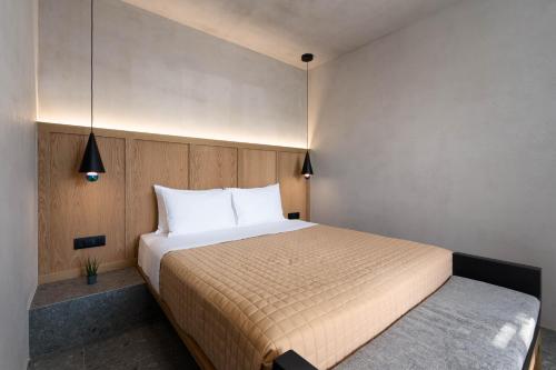 a bedroom with a large bed with white pillows at La Torretta Suites & Spa in Pirgos