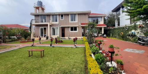a house with a lawn in front of it at Velus Bungalow Ooty in Ooty