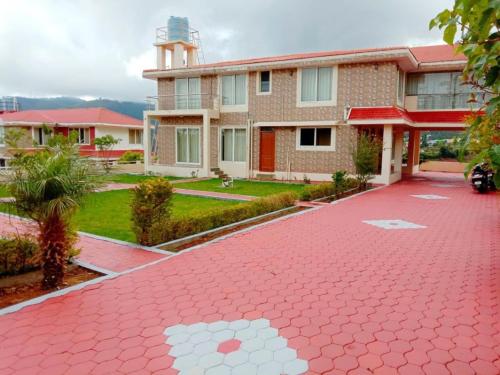a red brick driveway in front of a building at Velus Bungalow Ooty in Ooty