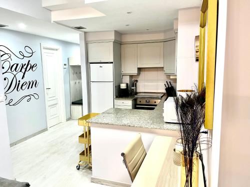 a kitchen with white cabinets and a counter top at Martina & Playa in Sanxenxo