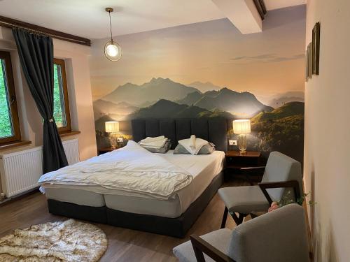 a bedroom with a bed with a mountain mural on the wall at Hotel Neda Galichnik in Galičnik