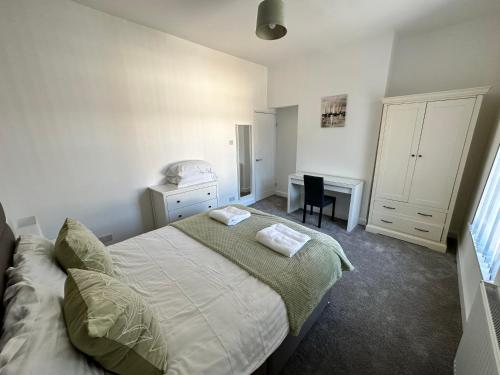 a bedroom with a bed and a desk in it at 4 bed house off Norton village in Stockton-on-Tees