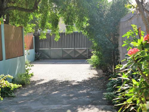 a driveway with a fence and a gate at La Kazette - Votre Studio de Vacances à l Île de La Réunion in Saint-Louis