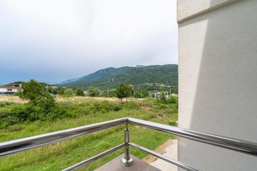 a balcony with a view of a mountain at MAS Apartments in Kotor