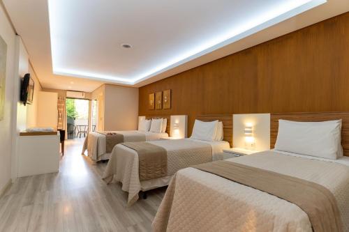 a hotel room with three beds in it at Piazito Park Hotel in Fragosos